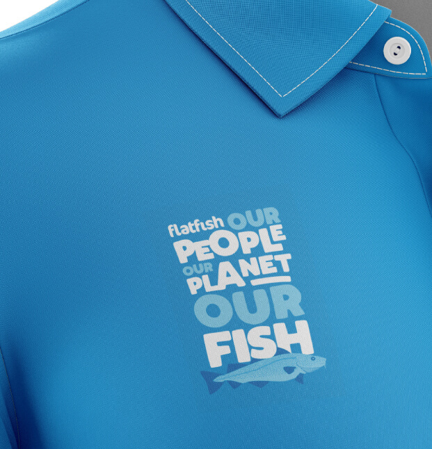 Flatfish logo on a blue polo shirt - close up