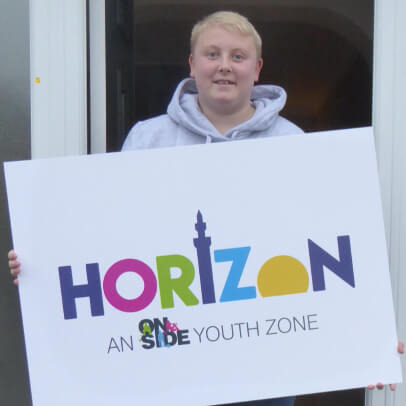 Teenager holding Horizon Youth Zone placard / sign