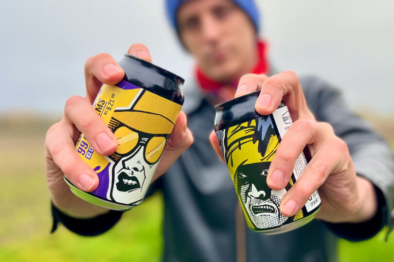 Sourcefour designer Kirk holding both Docks Beers x Beer52 craft beer cans