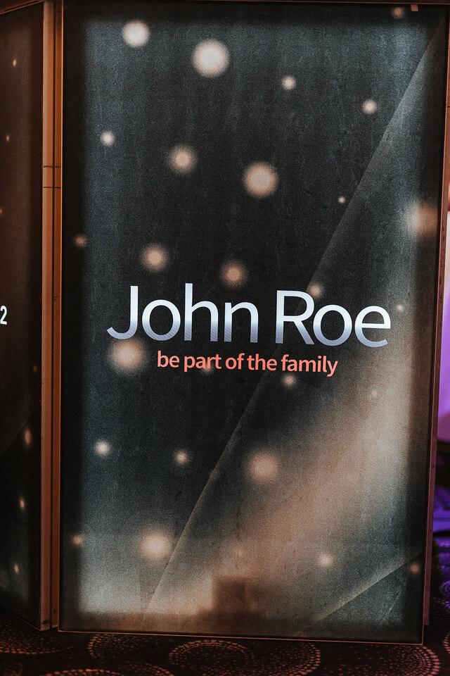 A sign that says John Roe celebrates 50 years in business and the Ichiban Award with Sourcefour.
