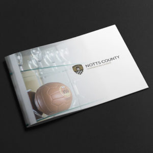 A black and white brochure with a football on it advertising Notts County FC Conferencing events project.
